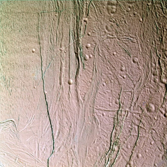 This false-color, close-up look at Enceladus yields new insight into the different processes that have shaped the moon’s icy surface. Extending through the center of this image, a system of two-mile (three-kilometer) wide rifts and 12-mile (20-kilometer) wide lanes of grooved terrain separate two distinct geological provinces on Enceladus. To the right of the boundary is older, cratered terrain. 