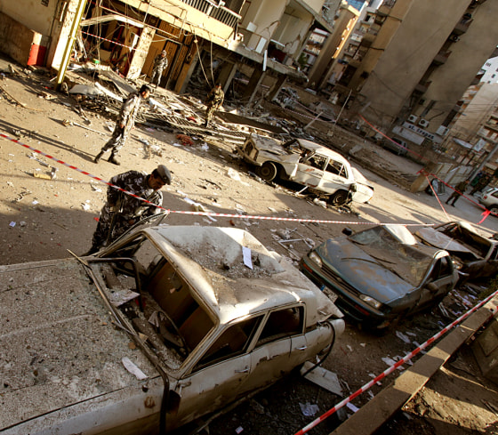 A police officer looks at a damaged vehicle after a car bomb exploded in the New Jdeideh neighborhood, in the northern suburbs of Beirut, Lebanon, on Saturday.