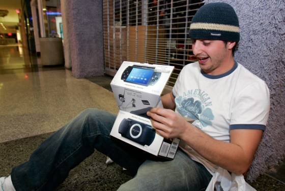 Martin Khalaf opens his PlayStation Portable after he waited in line for hours in El Cajon, California