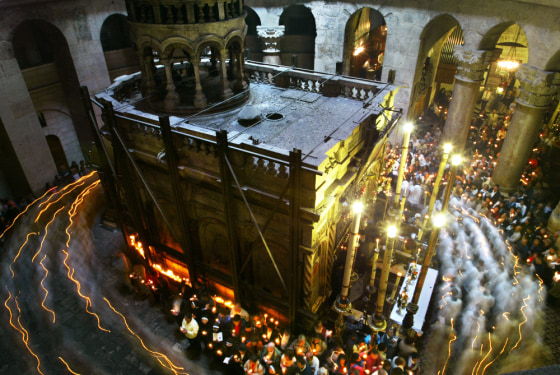 Following an Easter Sunday Mass, Catholic priests and pilgrims walk in a candle-light procession around the structure within the Church of the Holy Sepulcher which Roman Catholics believe is the tomb of Jesus Christ.