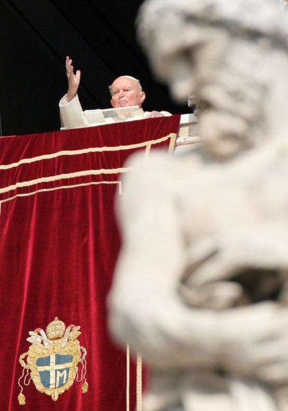 Pope John Paul II gives his blessing as he appears at the window of his studio overlooking St. Peter's Square at the Vatican, Wednesday.