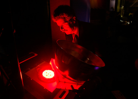 Bill Wolfson of Lamina Ceramics removes a ring from their Alterion LED light at the Lightfare International lighting convention in New York.