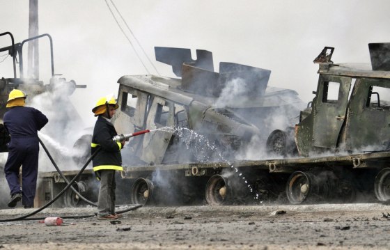 Iraqi firefighters try to extinguish a fire after a car bomb exploded near a U.S. convoy in western Baghdad on Wednesday.