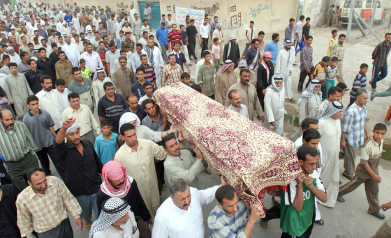 Iraqis carry the coffin of a man killed when suicide car bombs exploded Sunday near a market in a Shiite-dominated neighborhood of Baghdad.