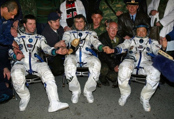 Italian ESA astronaut Roberto Vittori, Russian cosmonaut Salizhan Sharipov and NASA astronaut Leroy Chiao clasp hands shortly upon their arrival in the Kazakh town of Arkalyk early Monday.