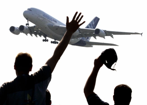 Spectators wave as they watch the world's biggest airliner, the Airbus A380, taking off on its maiden flight in southwestern France