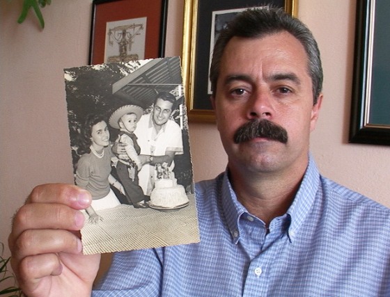 Carlos Cremata shows an old family photo with his mother and father. His father was killed, along with 72 others, in the bombing of Cubana Flight 455 in 1976.