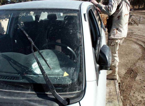 U.S. military personnel are seen near a car said to be that in which Italian journalist Giuliana Sgrena was traveling with slain Italian agent Nicola Calipari, in this photo released March 8 by the Italian RAI national television network. 