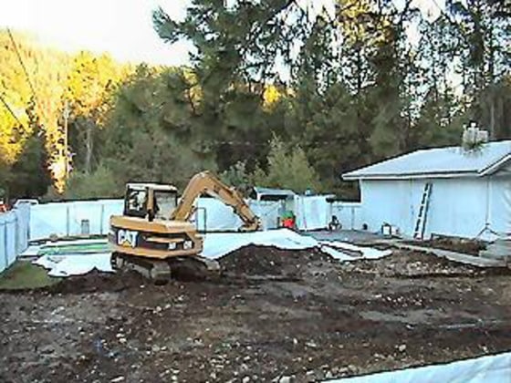 Asbestos removal work in Libby, Mont., has included removing topsoil from backyards like this one. The town's special treatment in an asbestos fund bill could undermine the entire package.