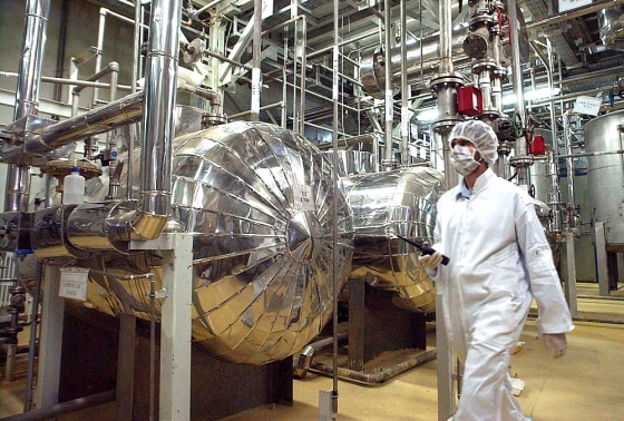 Wearing protective clothes, an Iranian security worker walks in the Uranium Conversion Facility just outside the city of Isfahan before the arrival of Iranian President Mohammad Khatami in this March file photo.