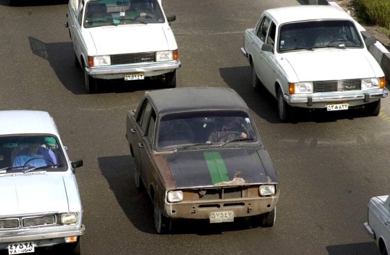 Various models of the Iranian-made Paykan are shown on the road in this 2001 file photo. Iran ended production of the country's most popular car Sunday after nearly four decades