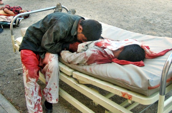 Jamil Abdul Husain grieves for his brother Haydar Abdul Husain, 25, on May 11 after he was killed when a suicide car bomb exploded in a market in Tikrit, north of Baghdad. More than 480 people, most civilians, have been killed by bombings and other insurgent attacks since Iraq's new government was announced on April 28.