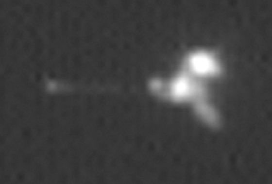 This image is an enlargement of a photograph of the Mars Odyssey probe taken by NASA's Mars Global Surveyor probe while the two spacecraft were 56 miles (90 kilometers) apart.