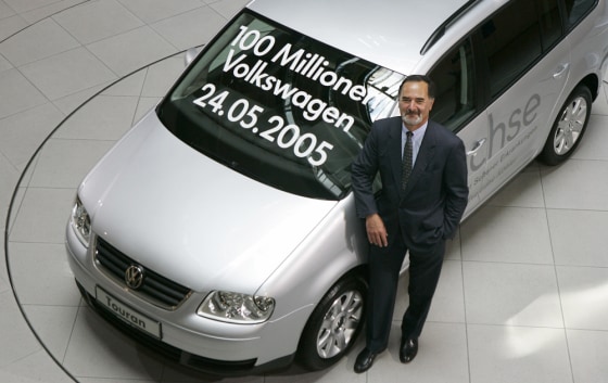 CEO Pischetsrieder of German car giant Volkswagen AG poses beside the 100th million produced Volkswagen vehicle in Berlin