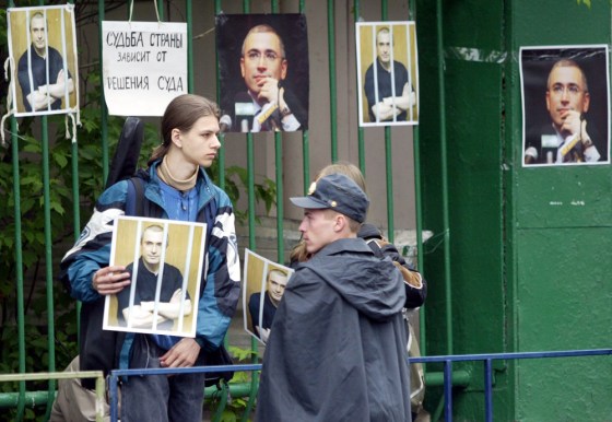 A policeman stands guard as supporters o