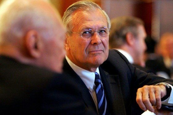 US Secretary of Defense Donald Rumsfeld looks on as Singapore Minister Mentor Lee sits to his left at a dinner in Singapore