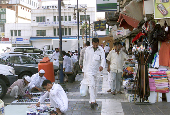 Men walk at a street in the Saudi Red Se