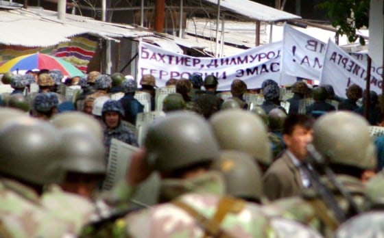 Uzbek army soldiers and riot police bloc