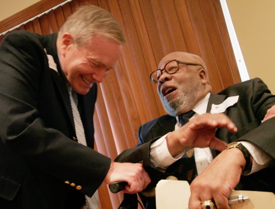 Wesley Brown, right, the first African American to graduate from the U.S. Naval Academy, jokes with fellow 1949 graduate Bill Read during a luncheon held in his honor, on Friday. 