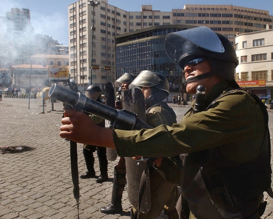 Riot police fire tear gas at demonstrators during clashes in downtown La Paz on Tuesday. 
