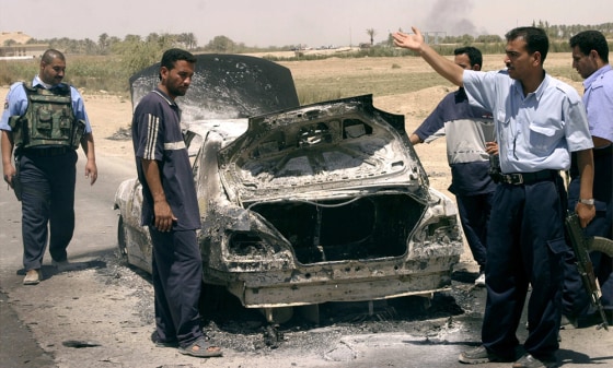 Iraqi police direct traffic after roadside bomb attack kills three near Falluja