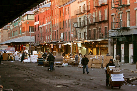 Runners cart seafood orders from storefronts to trucks at the Fulton Fish Market. The open-air market comes alive with boisterous bartering starting after midnight and winds down at dawn.