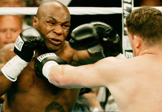 Irishman McBride hits Mike Tyson during their heavyweight title fight in Washington