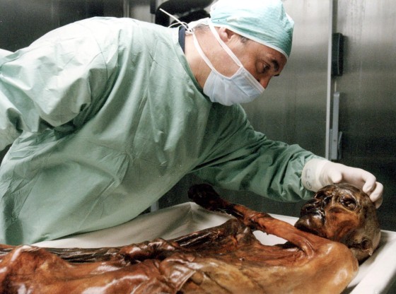 A researcher inspects the 5,000-year-old mummy known as Oetzi in this file photo from 2000. Oetzi is kept in a sealed-off chamber which researchers now worry may have been penetrated.