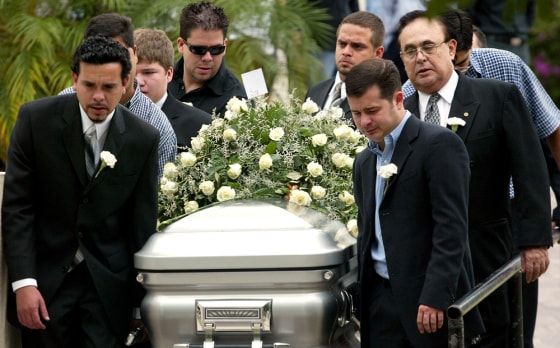 Relatives and friends of security chief Alejandro Dominguez accompany the castket carrying his body following a Mass in Nuevo Laredo, Mexico, on Friday. The border police chief was gunned down just hours after taking over the post.
