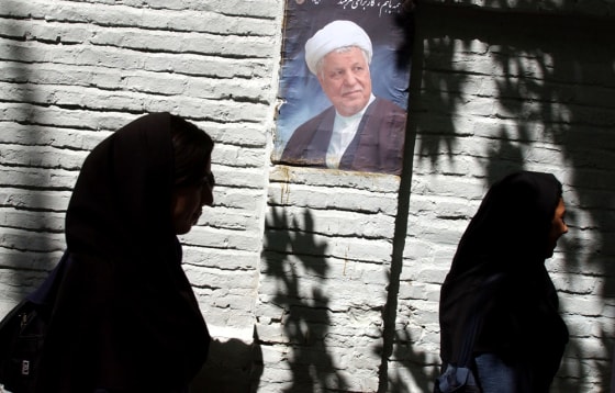 Two Iranian women pass by a poster of former President Akbar Hashemi Rafsanjani, a leading candidate for the June 17 Iranian presidential election. Rafsanjani has used Iran's nuclear program — and the international concerns surrounding it — as a campaign booster.