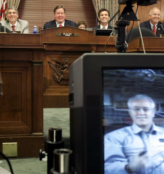 Reps. Tom Udall, Ken Calvert, Jo Bonner and others listen to testimony from U.S. astronaut John Phillips beamed live from the international space station during a Capitol Hill hearing Tuesday.