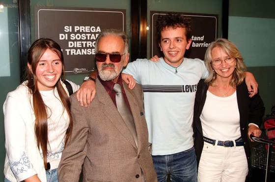 Giorgio Angelozzi, second from left, is welcomed by his 'adoptive' family at the Orio al Serio airport in northern Italy on Sept. 25. Angelozzi has since disappeared, leaving behind $2,860 in debt.