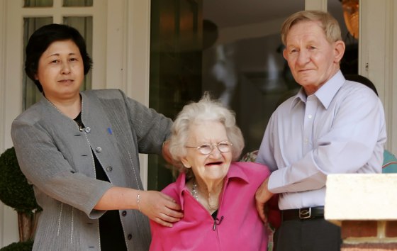 Jenkins holds onto his mother on the porch of his sister's home in Weldon
