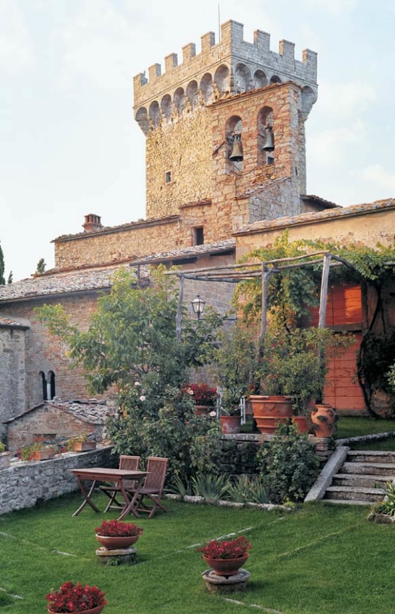 The garden at Castello di Gargonza, with the castle's medieval tower looming above