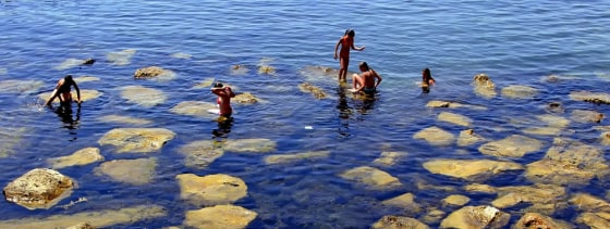 Italians seek relief from soaring temperatures at the beach in Civitavecchia, Italy