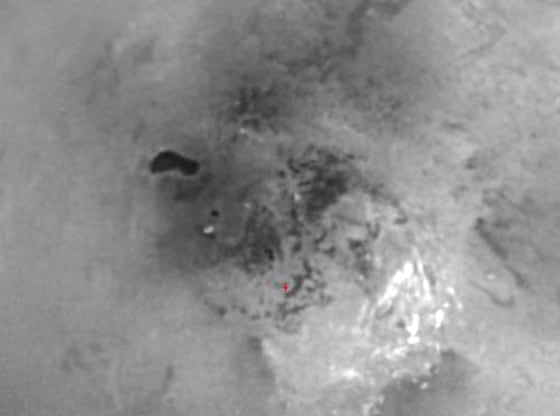 This view of Titan's south polar region reveals an intriguing dark feature that may be the site of a past or present lake of liquid hydrocarbons.