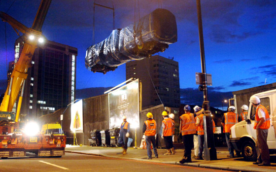 The mangled carriage where seven people died in the July 7 terrorist attack near Edgware Road Tube station in London is lifted Tuesday by crane off the track and on to a flatbed truck for further examination.