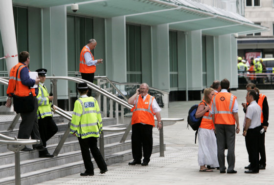 London Underground staff and police officers stand outside Warren Street station in central London on Thursday.