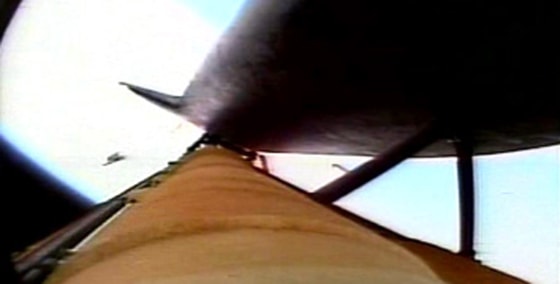 In this NASA TV image from the shuttle launch, a piece of material is seen coming off Discovery's external fuel tank.