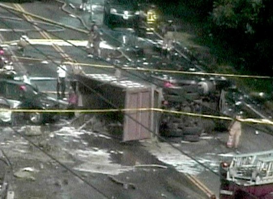 A dump truck lies on its side Friday after a fiery crash shut down Route 44 near Avon, Conn. 
