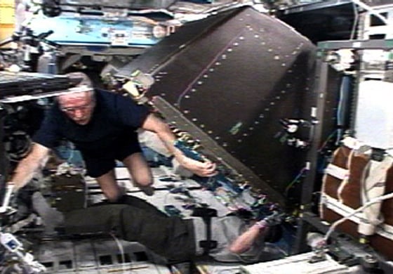 Crew member Phillips and Discovery Pilot Kelly work in the Destiny laboratory of the International Space Station