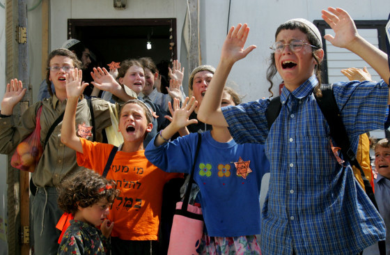 Wearing Stars of David, children of Gaza settlers employ Nazi-era imagery in protest against their forced removal by Israeli troops from their home Wednesday at the Kerem Atzmona settlement in the Gaza Strip.