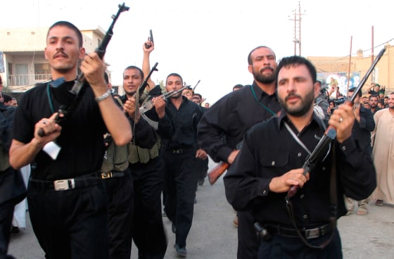 Members of Shi'ite Badr Brigade militia march on anniversary of coalition air strike in southern Iraqi town of Kut