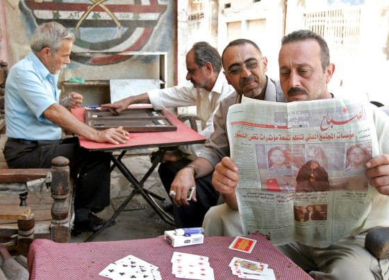Men read&nbsp;about the latest political wrangling in local newspapers outside a coffee shop in downtown&nbsp;Baghdad on Tuesday.