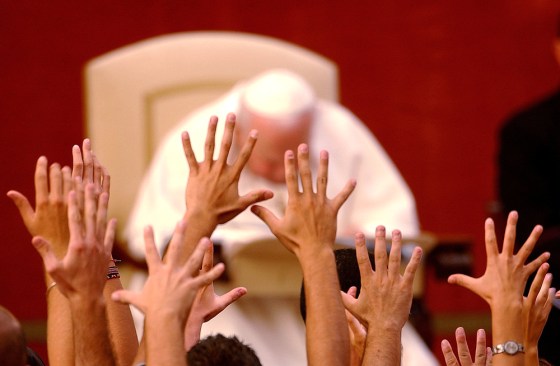 Faithful raise their hands in front of Pope John Paul II in Castelgandolfo, Italy, in this 2003 photo. John Paul II's secretary recently said the pope heard his follower's prayers as he lay on his deathbed.