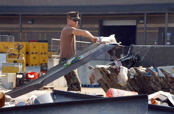 A U.S. Navy Seabee discards spoiled goods from the Naval Construction Battalion Center Gulfport Commissary Sept. 4, 2005. Katrina's growing costs are likely to approach $200 billion in the next couple of weeks.