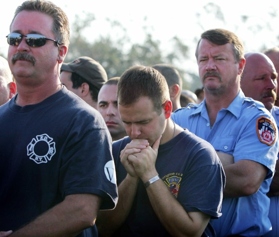 Members of the New York Fire Department stand during mass in New Orleans