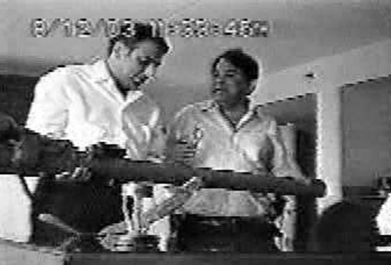 This image released by the New Jersey U.S. Attorney's Office purports to show British businessman Hemant Lakhani, 69, from London, right, allegedly attempting to sell a sample shoulder-fired missile to an unidentified FBI informant in a New Jersey hotel in August 2003.