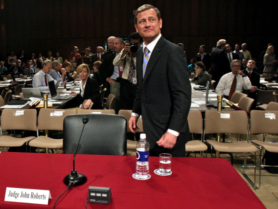 Supreme Court chief justice nominee John Roberts arrives at the witness table as confirmation hearings resumed Wednesday.