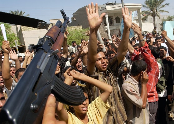 Iraqis protest in Basra, Iraq, on Wednesday, demanding an apology for Monday's attack by British forces on the jail where two British nationals were captive.
